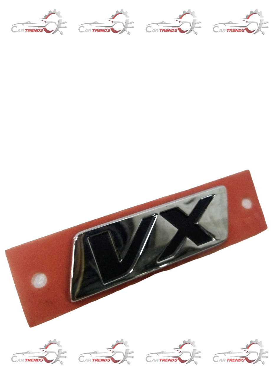 Honda EMBLEM.RR GRADE VX 75723TFMK40 badge, close-up of chrome Honda logo and emblem on vehicle surface
