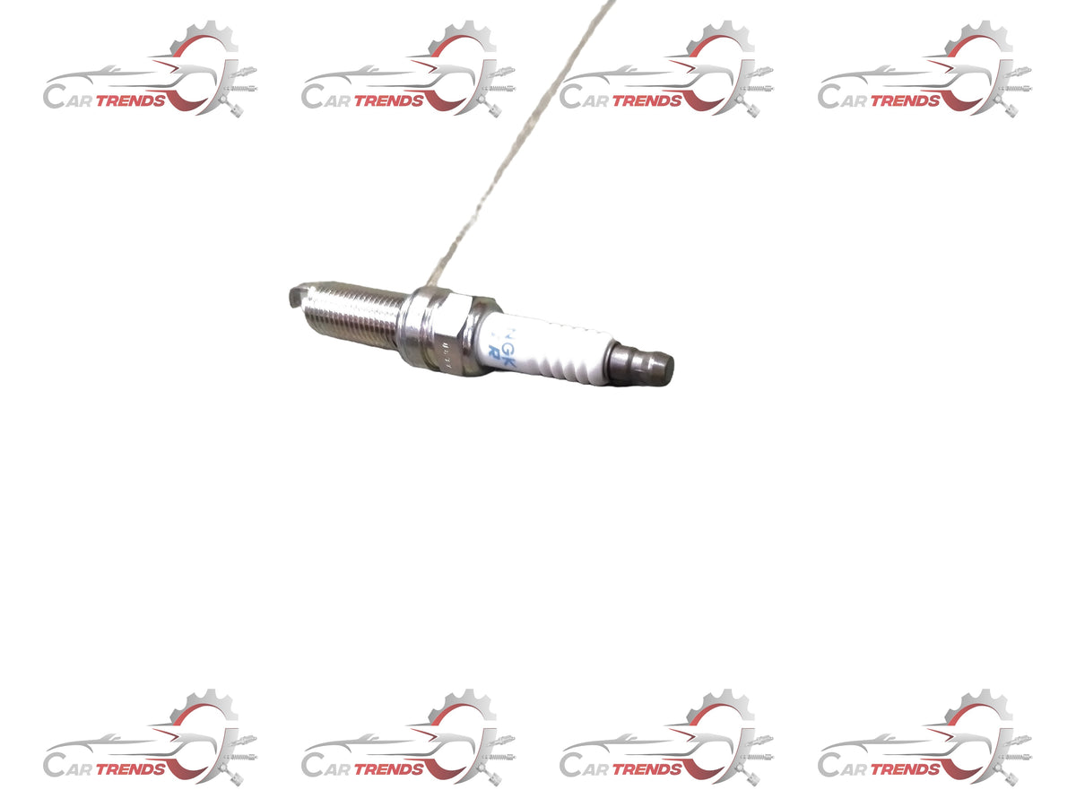 Maruti Suzuki spark plug for Celerio new model, part number 09482M00651, showing the metal electrode and ceramic insulator.