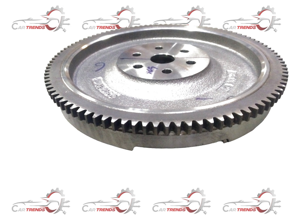 Maruti Suzuki flywheel component part, model 12620M68K12, showing the metallic surface and detailed gear teeth.