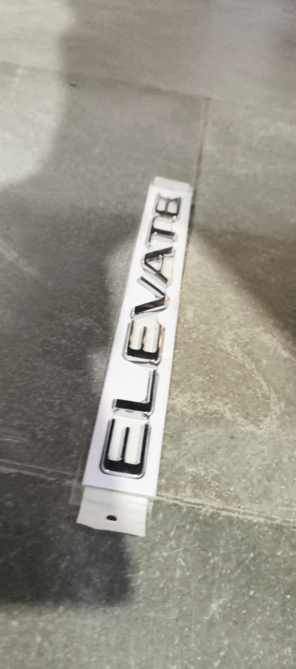 Honda emblem set with car name badge, featuring the Honda logo and model identifier in black lettering on a vehicle.