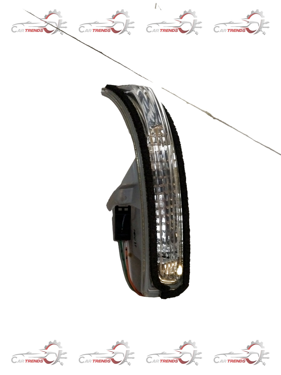 Maruti Suzuki side turn signal lamp assembly showing the clear lens and mounting bracket for vehicle lighting.