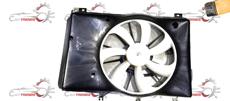 Maruti Suzuki fan assembly for Baleno, model 17100M54T00, showing the car's cooling fan and mounting components.
