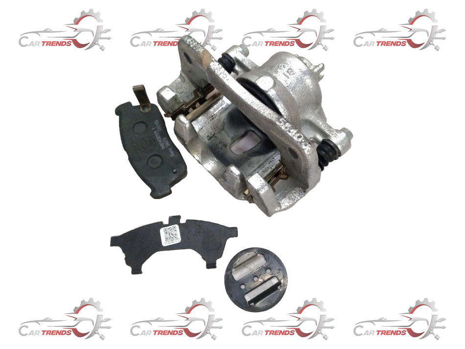 Front brake caliper assembly for Maruti Suzuki vehicle, showing the metallic brake caliper with mounting hardware.