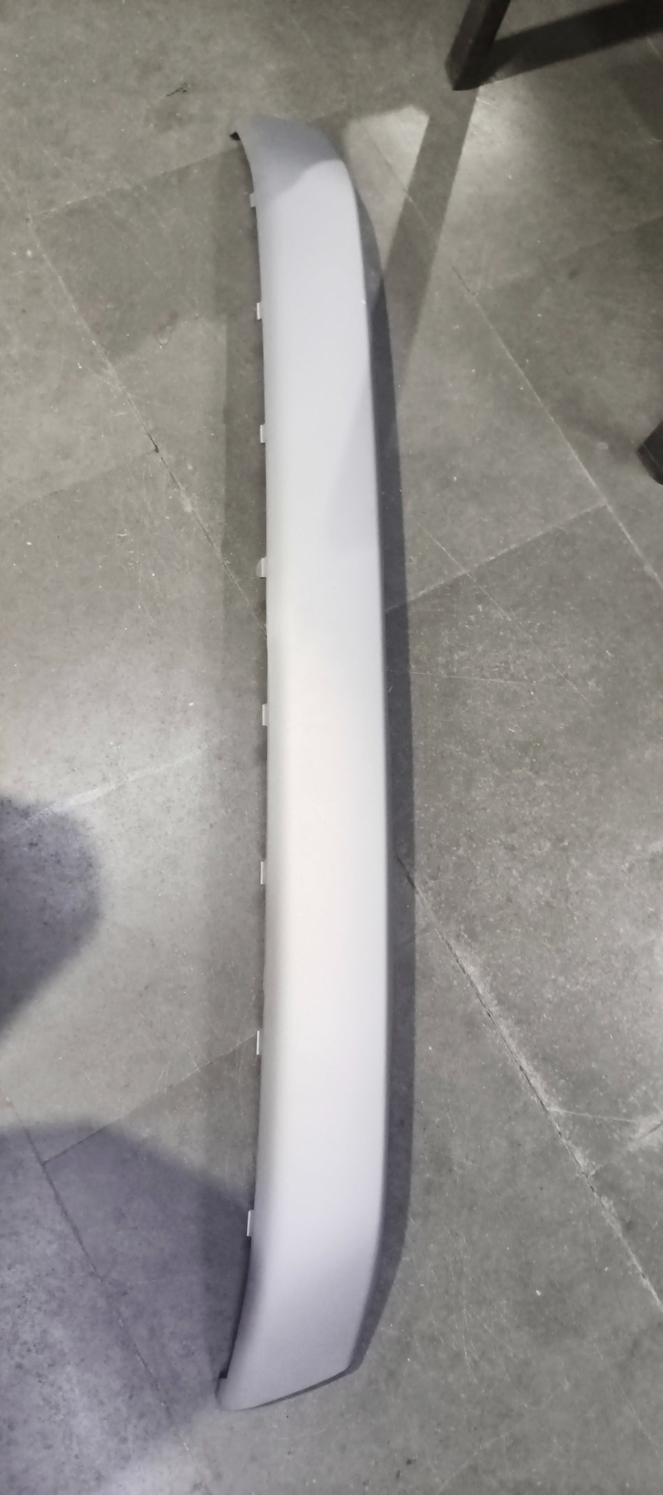 Maruti Suzuki garnish bumper lower part in black, designed for front bumper installation, shown in close-up view.
