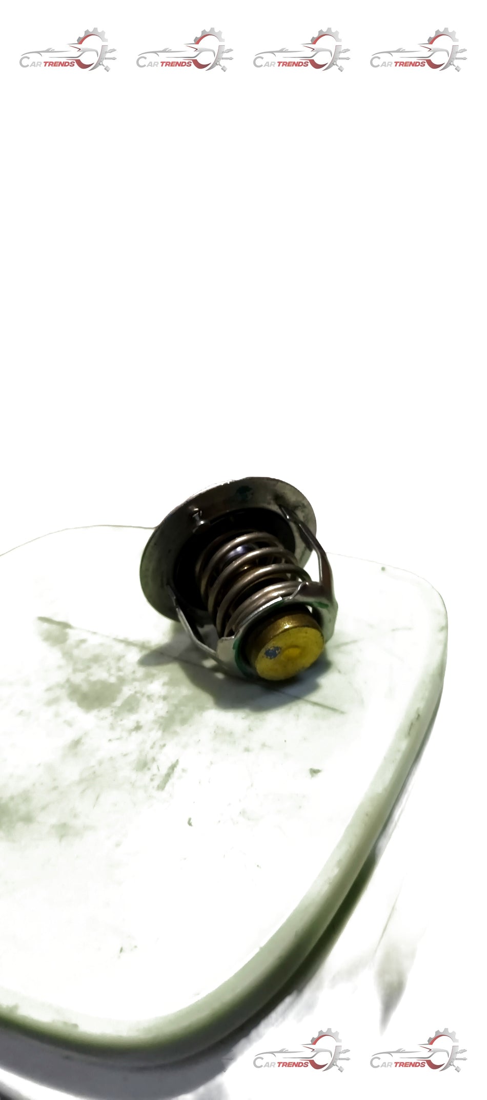 Maruti Suzuki Thermostat COMPWATER82 C 17670M85030 showing the metal housing and connection points for vehicle cooling system.