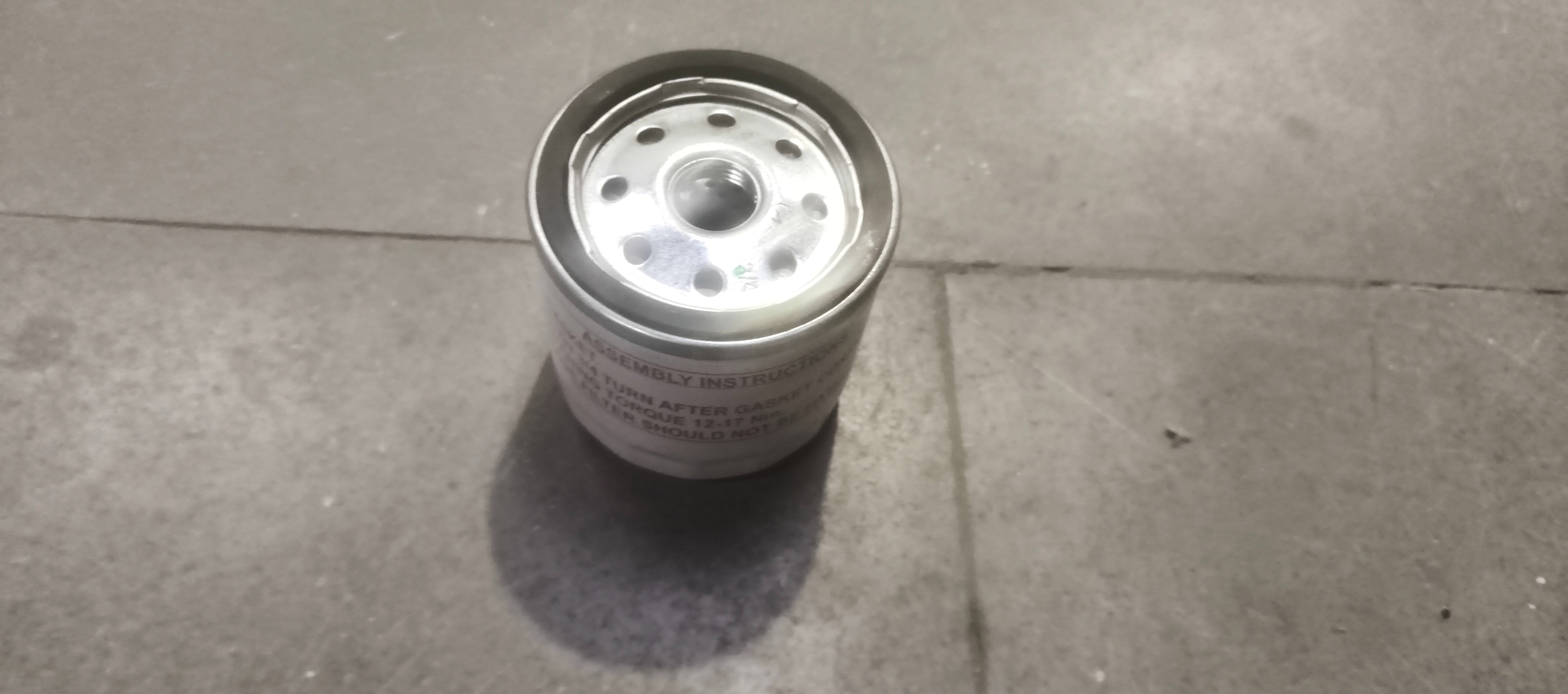 Ford EcoSport oil filter ECOSPORTS 7S7Z6731E, brand new filter shown with close-up of metal and rubber components.
