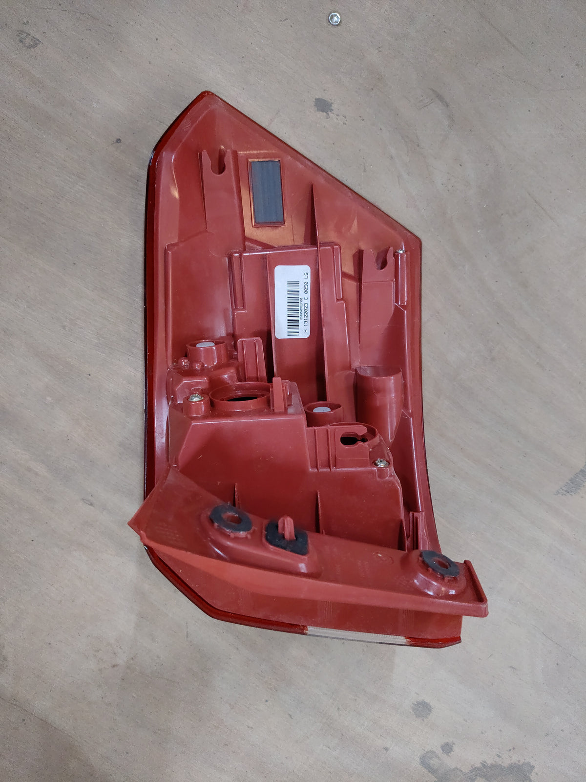 Left tail lamp for Breeza by CarTrends, spare parts image showing the red and clear lens with mounting brackets.
