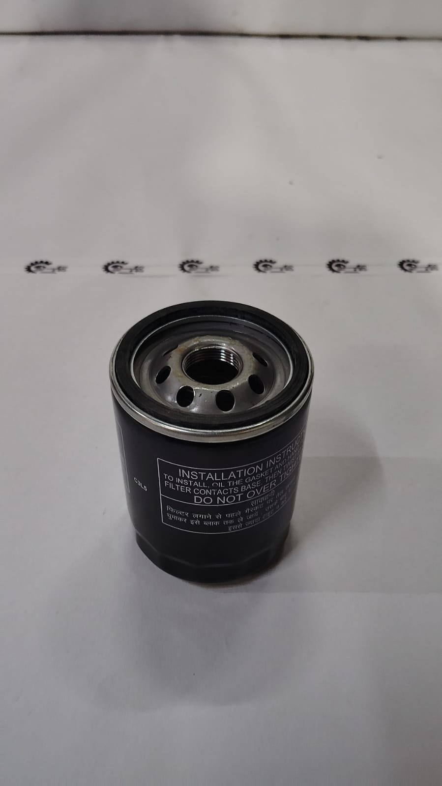 Tata Punch oil filter spare part with brand label, showing the black cylindrical filter for vehicle engine maintenance.