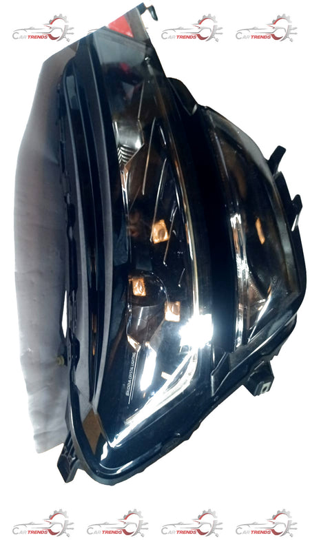 Volkswagen head lamp for Skoda Kushaq model, part number 6JP941015A, showing the illuminated front light with clear lens and housing.