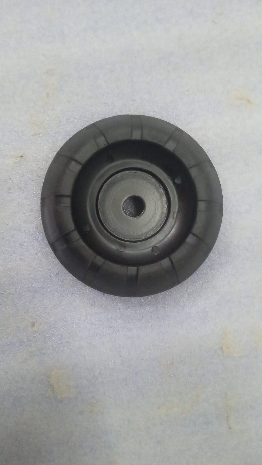 Aftermarket shocker mount for Maruti Suzuki Swift and Dzire, black metal component installed in the vehicle suspension system