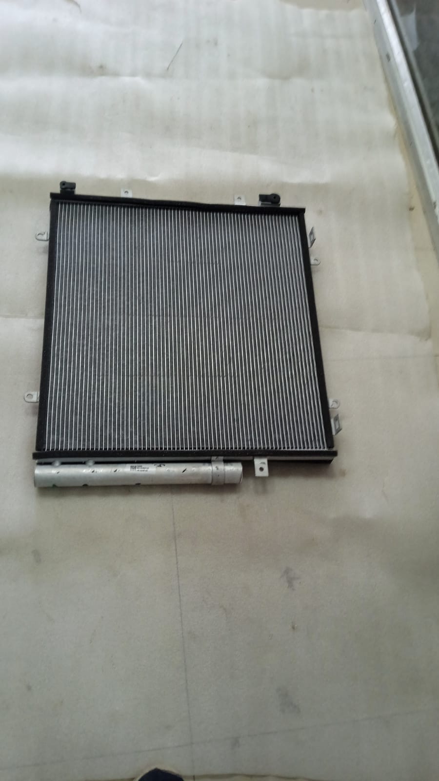 CarTrends condenser spare part for Suzuki Brezza Diesel, showing the metal cooling component with mounting points and connectors.