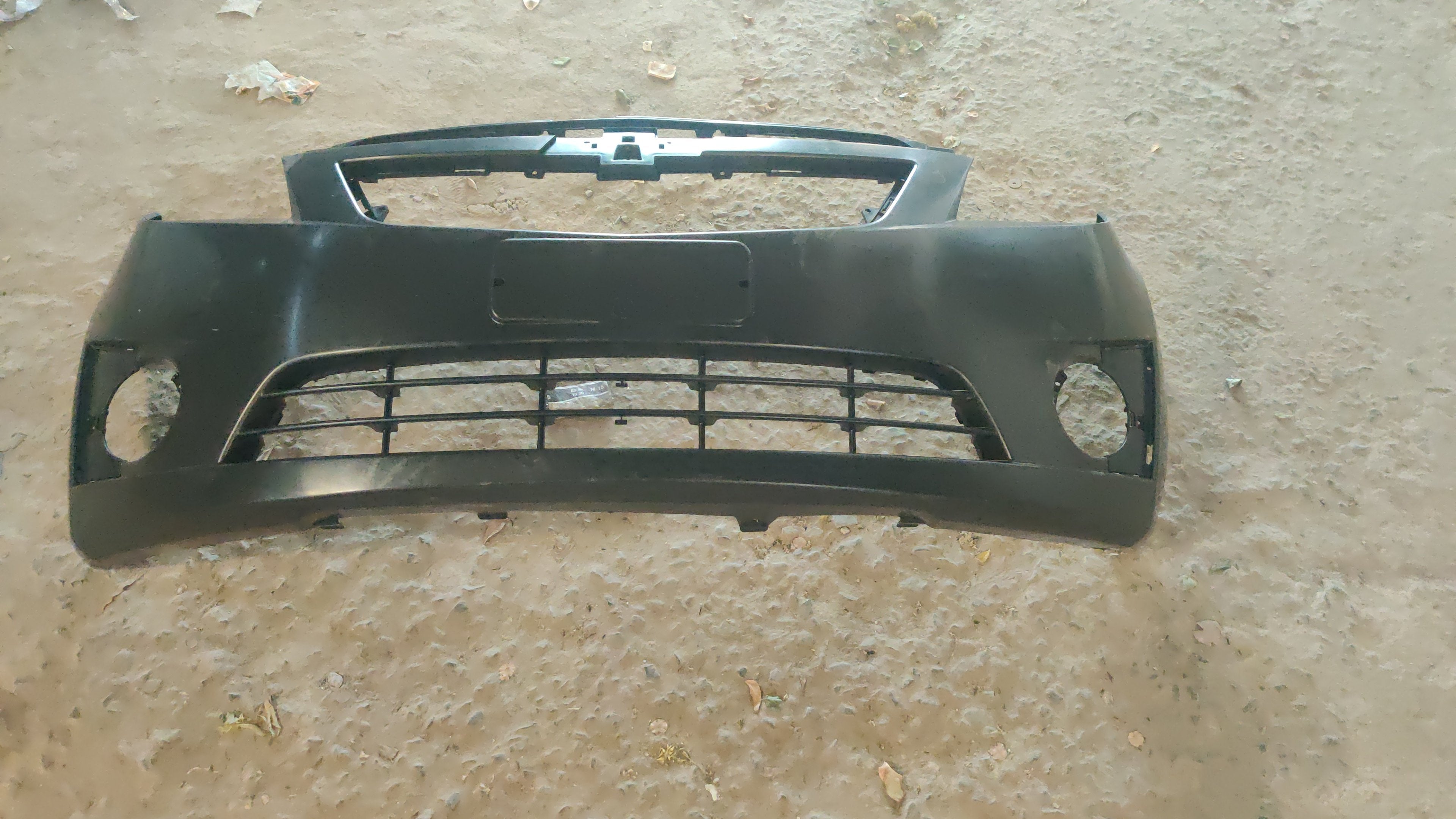 Chevrolet Beat front bumper spare part by CarTrends, showing the new bumper with mounting points and smooth finish.