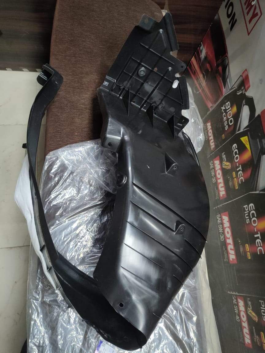 CarTrends right Fender lining for 2019 Swift, close-up of the durable plastic car spare part with mounting clips.