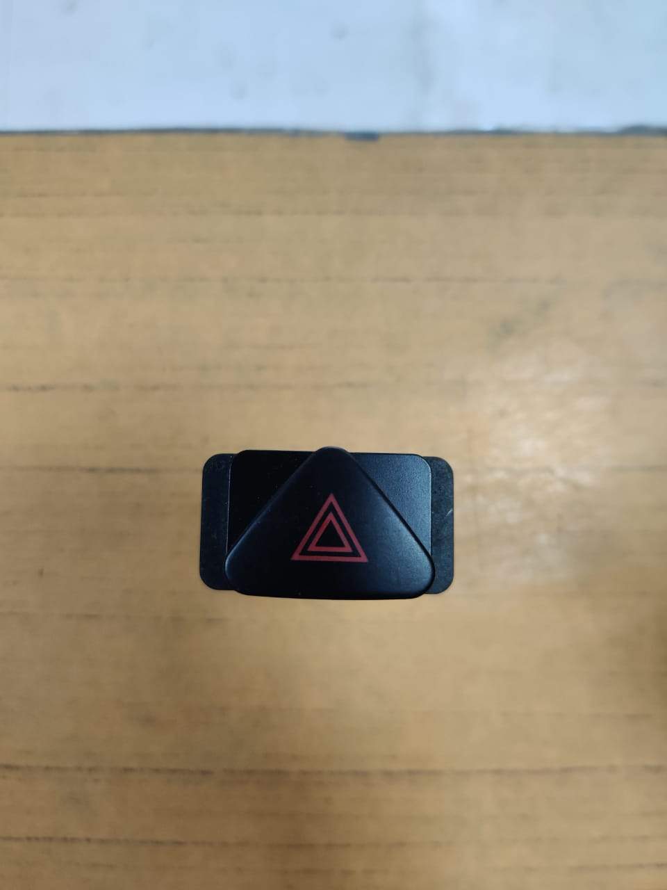 CarTrends hazard switch J23884830 spare part with black plastic button and wiring for vehicle safety system.