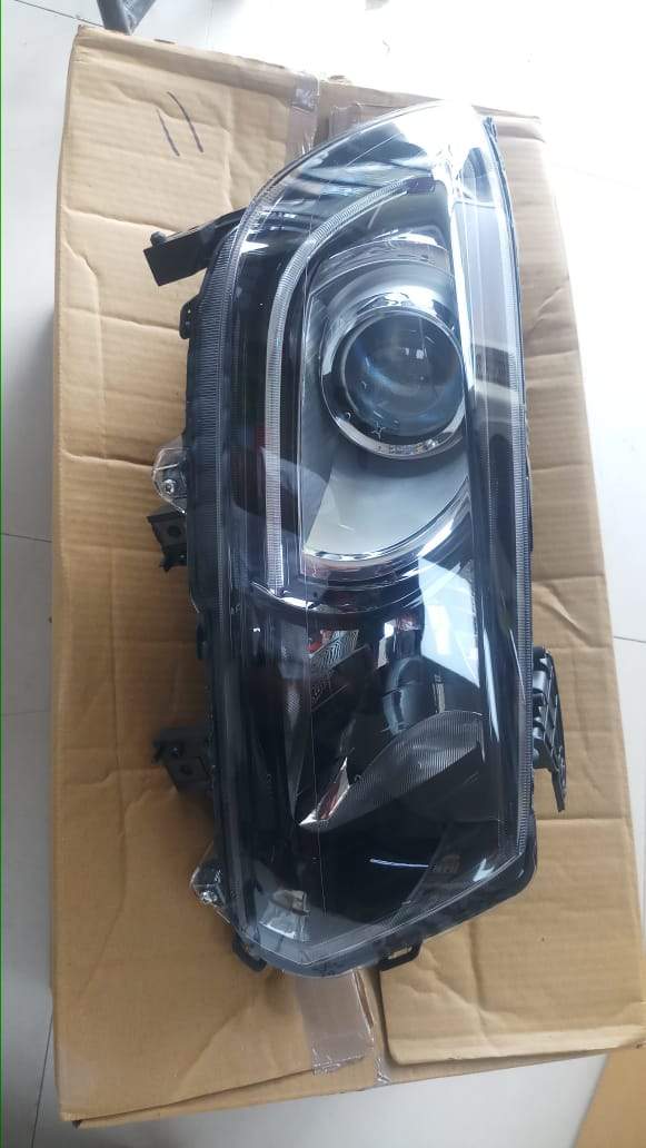 CarTrends head lamp for Vitara Brezza, left side LED spare part, close-up view showing the lamp's design and connector.