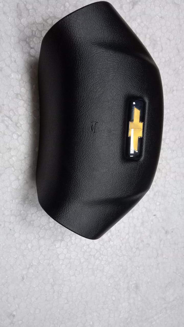 CarTrends horn pad for Tavera T97595801, spare vehicle part shown in close-up with textured surface and mounting details.