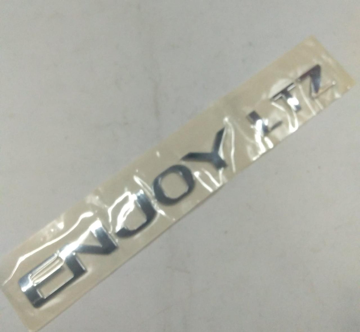 CarTrends emblem for Enjoy LTZ spare parts, featuring a detailed close-up of the vehicle emblem on a white background.