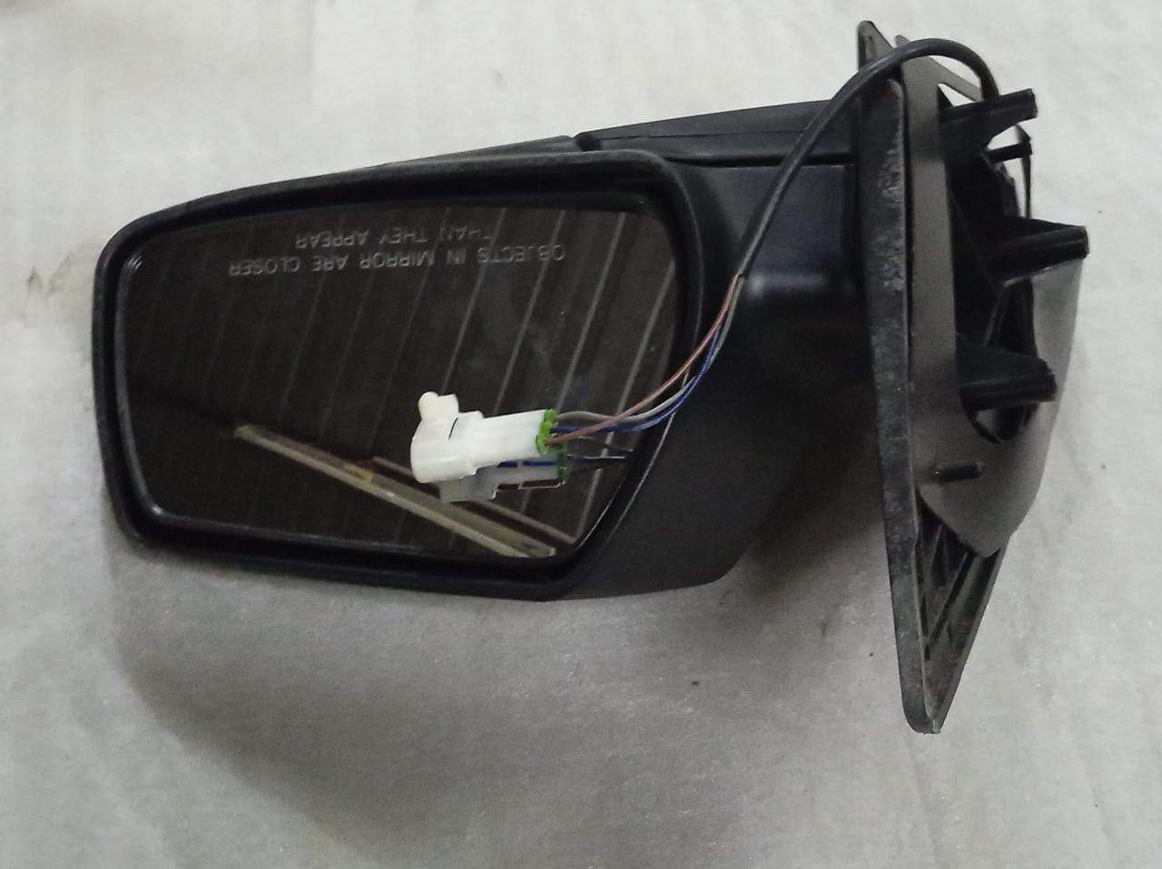 CarTrends J24548810 right side mirror for Enjoy model, close-up of the spare part showing its reflective surface and mounting area.