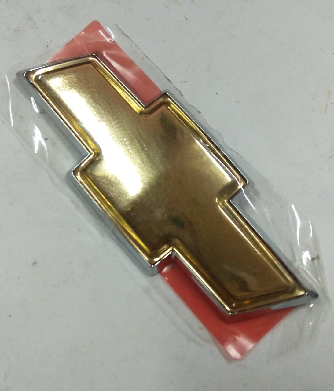 CarTrends Emblem Spark spare part, close-up of the shiny metallic emblem designed for vehicle decoration or branding.