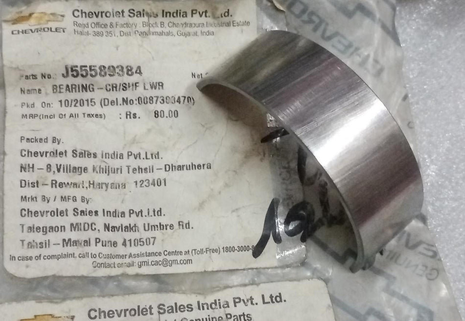 CarTrends Chevrolet Beat lower crankshaft bearing, close-up view of spare part for engine repair or replacement.