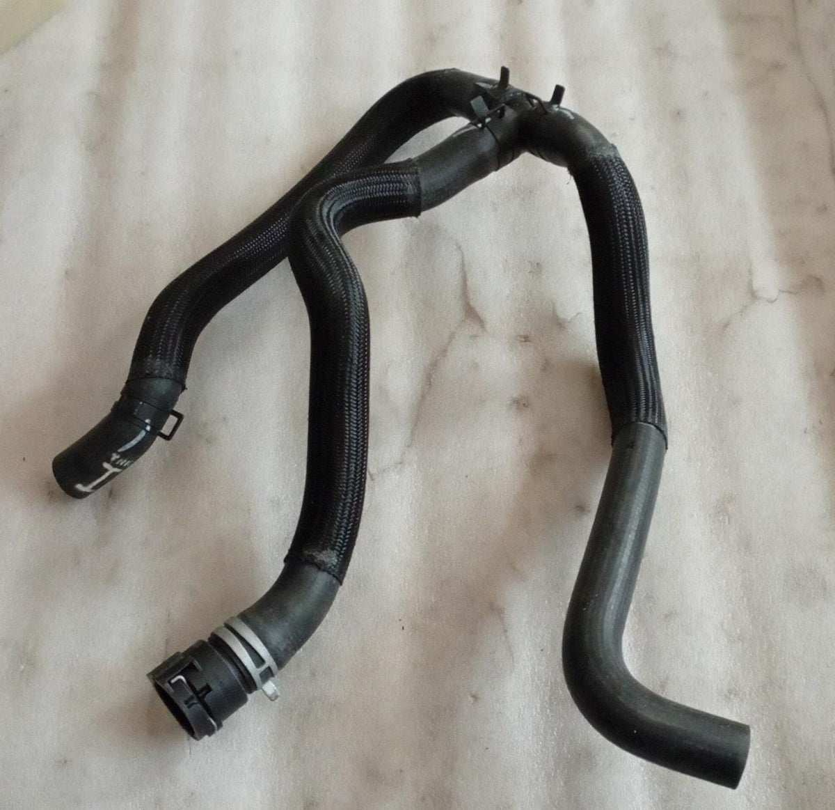 CarTrends heater core outlet hose for Captiva, spare part replacement showing the black hose and connection points.