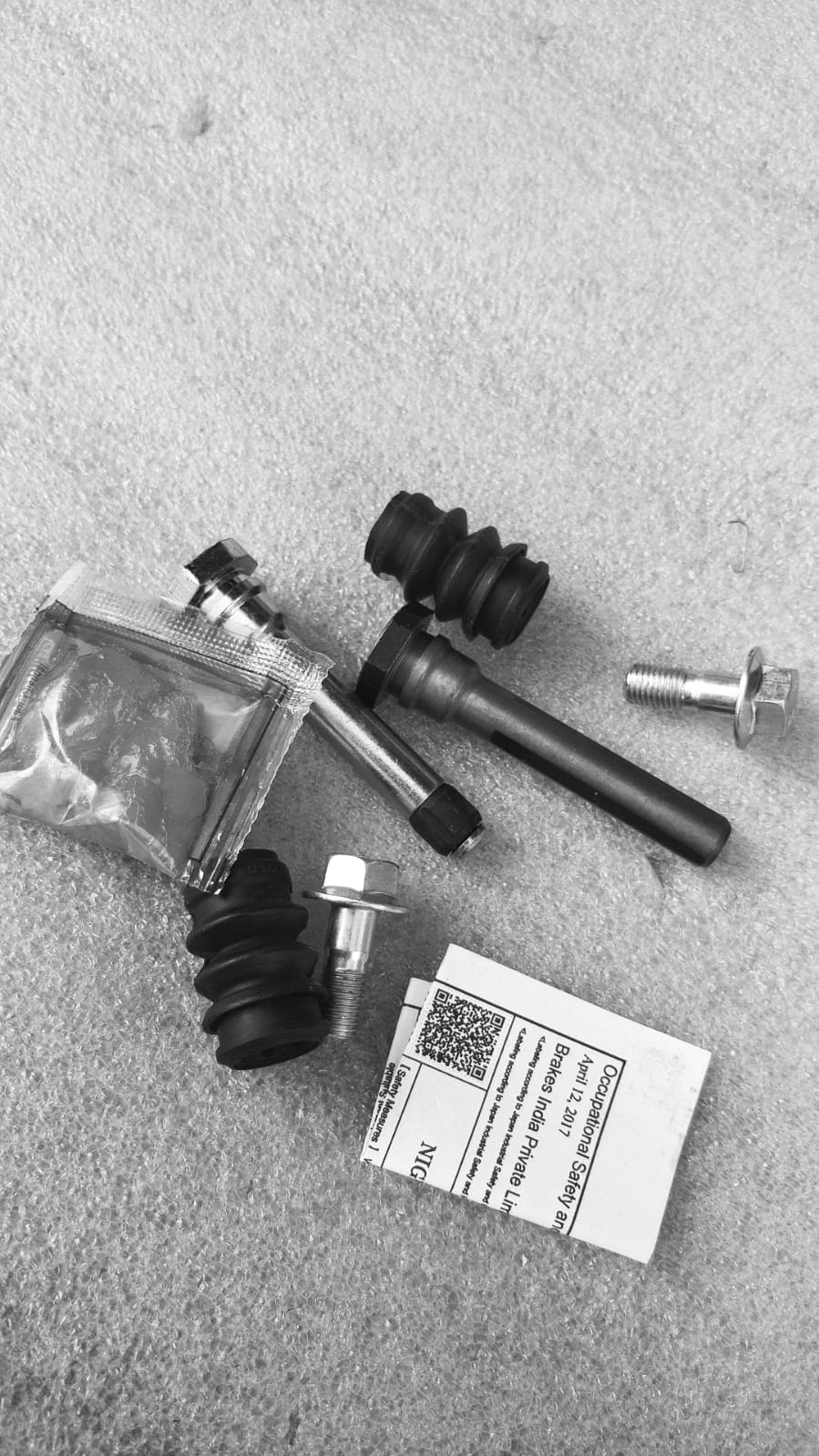 CarTrends sliding Baleno pin set spare parts, close-up of metal pins and components for vehicle maintenance.