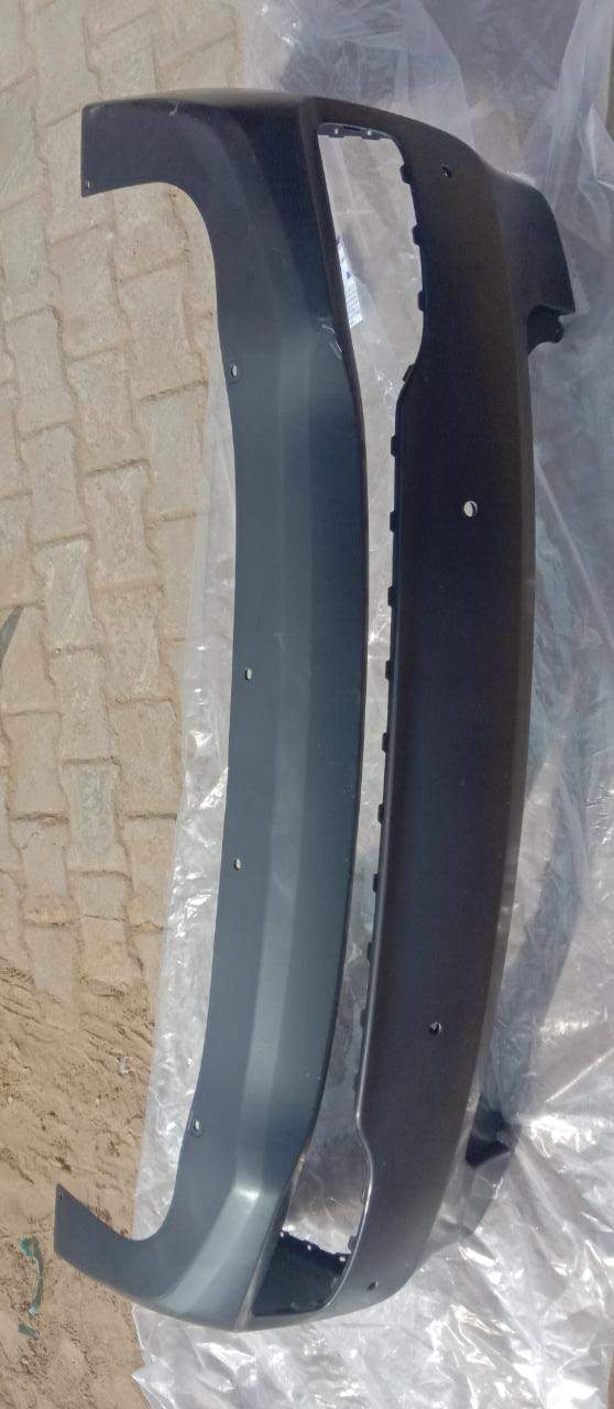 CarTrends rear bumper for Xcent, new modal spare part, shown in a close-up view of the bumper's surface and mounting points.