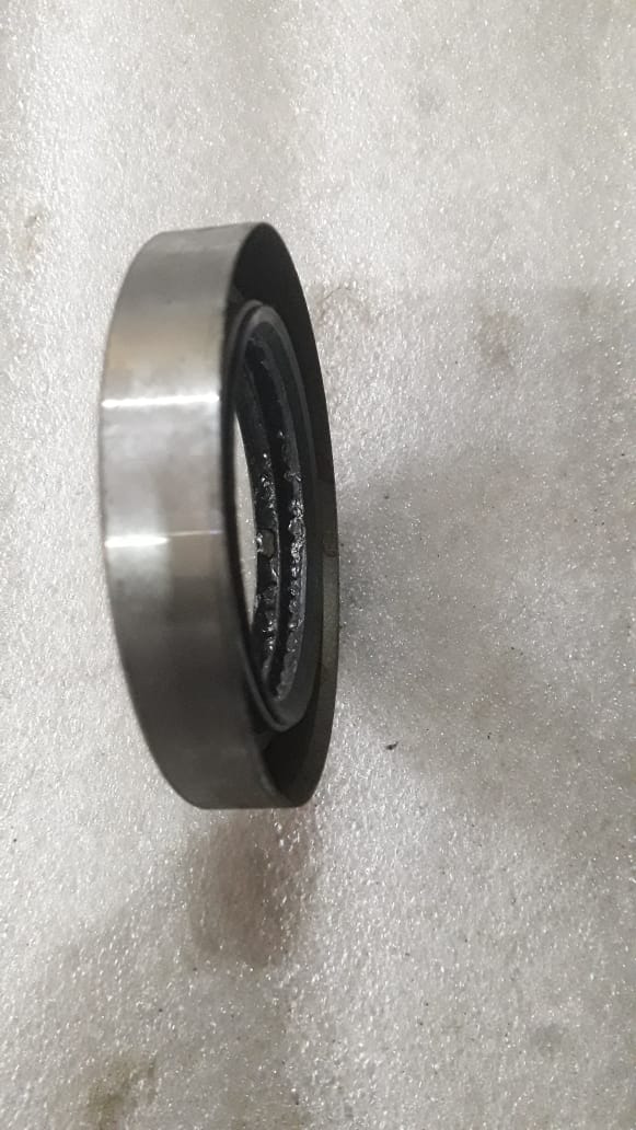 CarTrends T94318909 Oil Bearing Seal for Tavera, spare parts component showing the seal and hole in close-up.