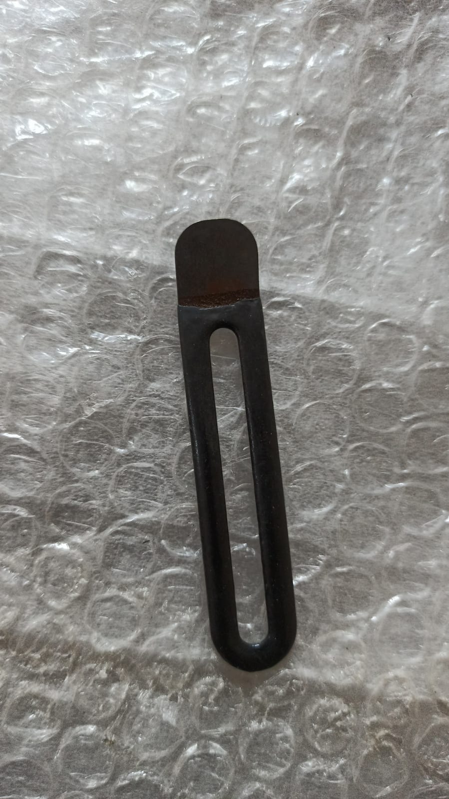 CarTrends T97596461 insulation clip for Tavera, spare part shown in black plastic with metal fastening tab.