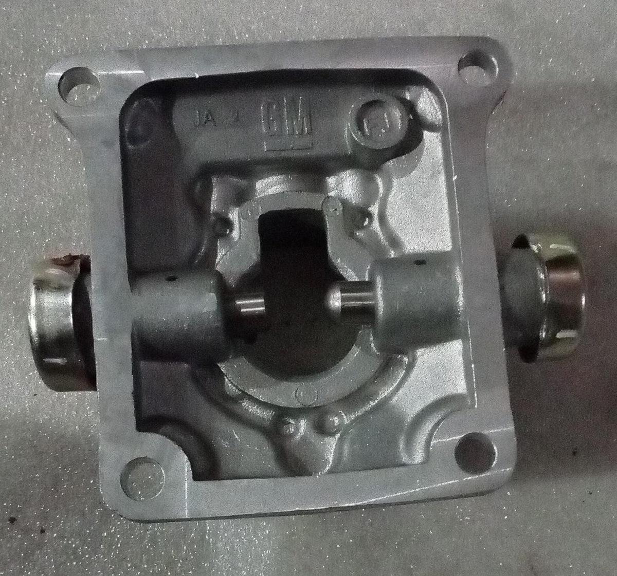 CarTrends Chevrolet Tavera transmission quad box spare part, showing the metal transmission component with mounting points.