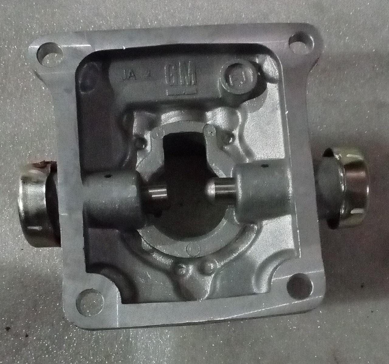 CarTrends Chevrolet Tavera transmission quad box spare part, showing the metal transmission component with mounting points.
