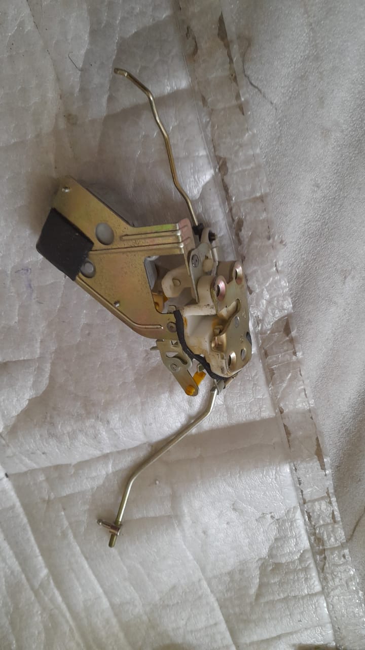 Front door latch for Tavera, CarTrends spare part, showing the metal latch mechanism for vehicle front door.