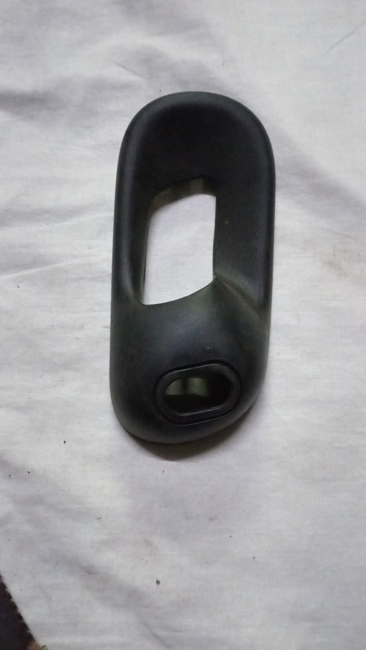 Rear right glass bezel inside handle for Chevrolet Corsa, designed by General Motors, shown in the image.