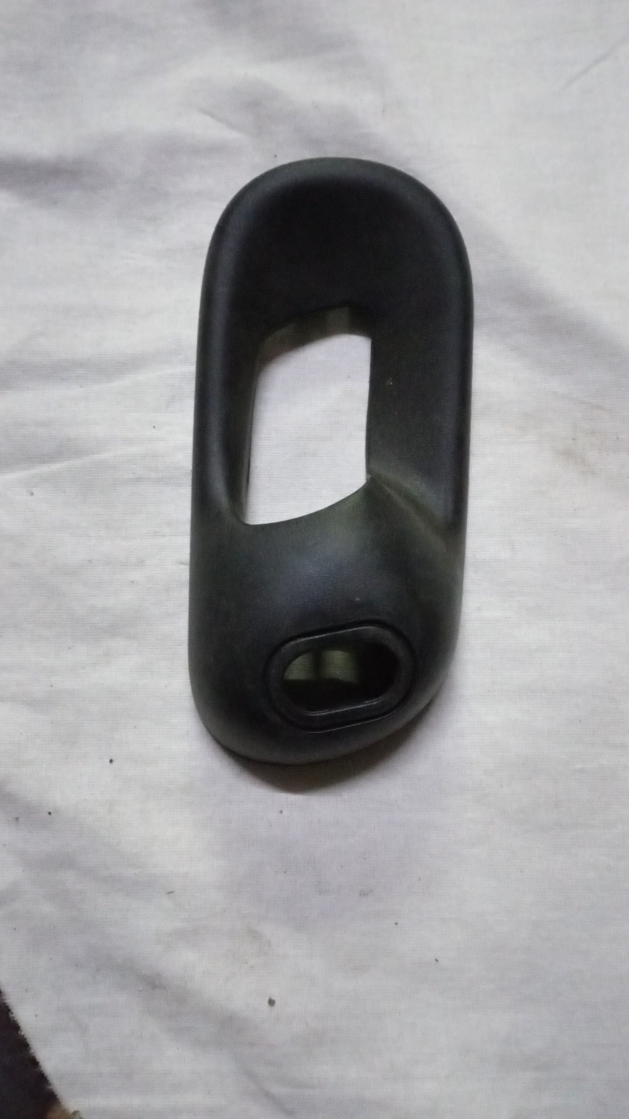 Rear right glass bezel inside handle for Chevrolet Corsa, designed by General Motors, shown in the image.