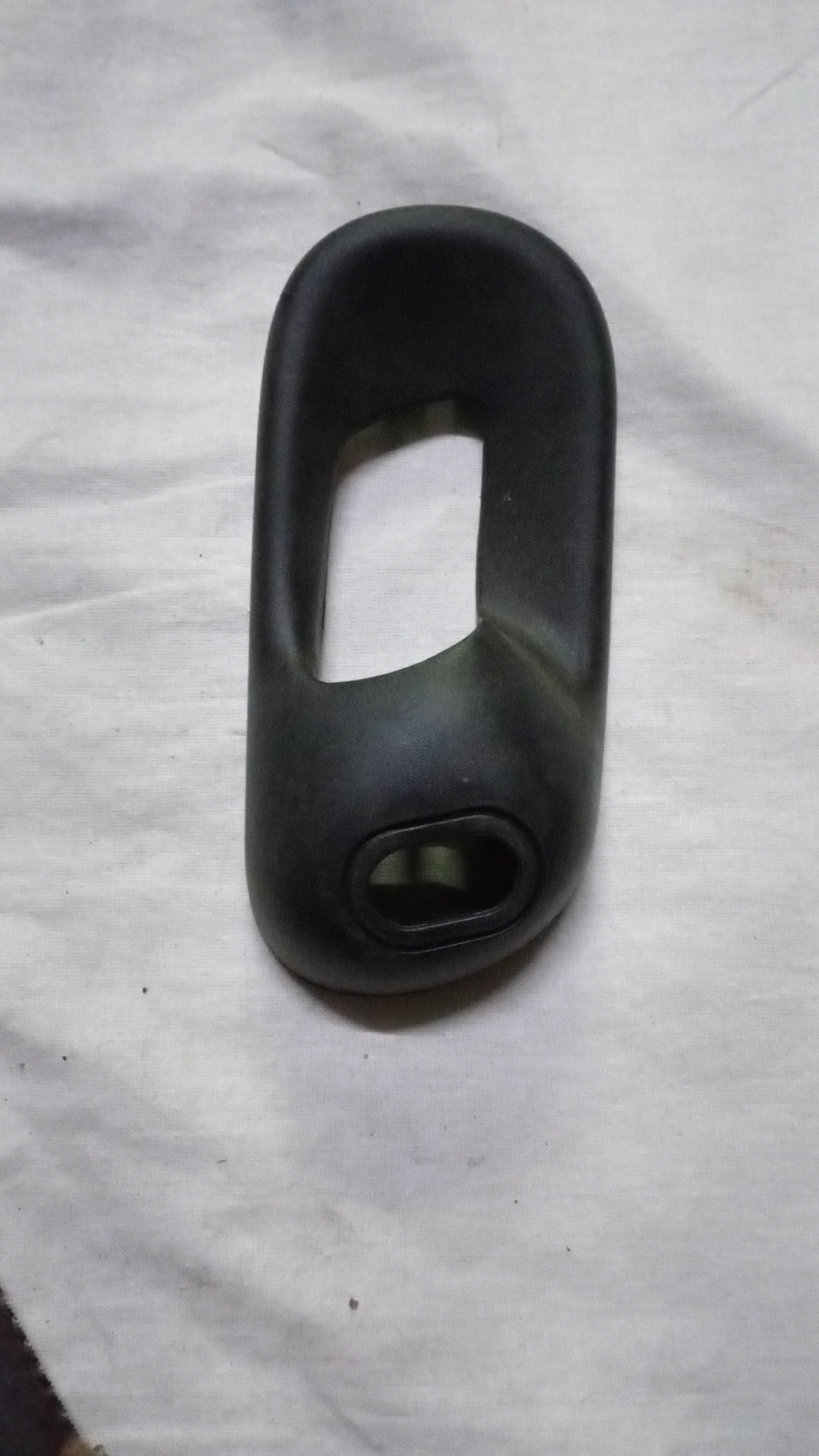 Rear right glass bezel inside handle for Chevrolet Corsa, designed by General Motors, shown in the image.