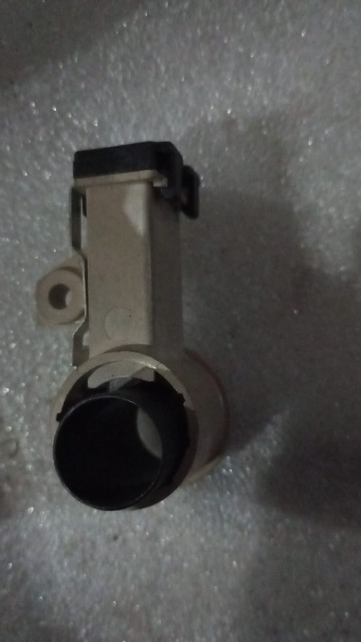 General Motors Chevrolet Spark brush part, shown in black with metal bristles, designed for vehicle maintenance.