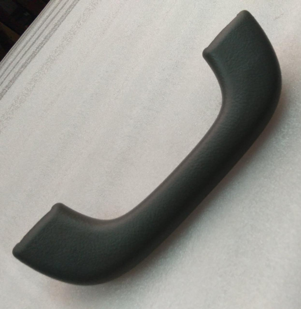 General Motors Grip A Assist for Optra Petrol, black rubber handle with textured grip and metal mounting hardware.