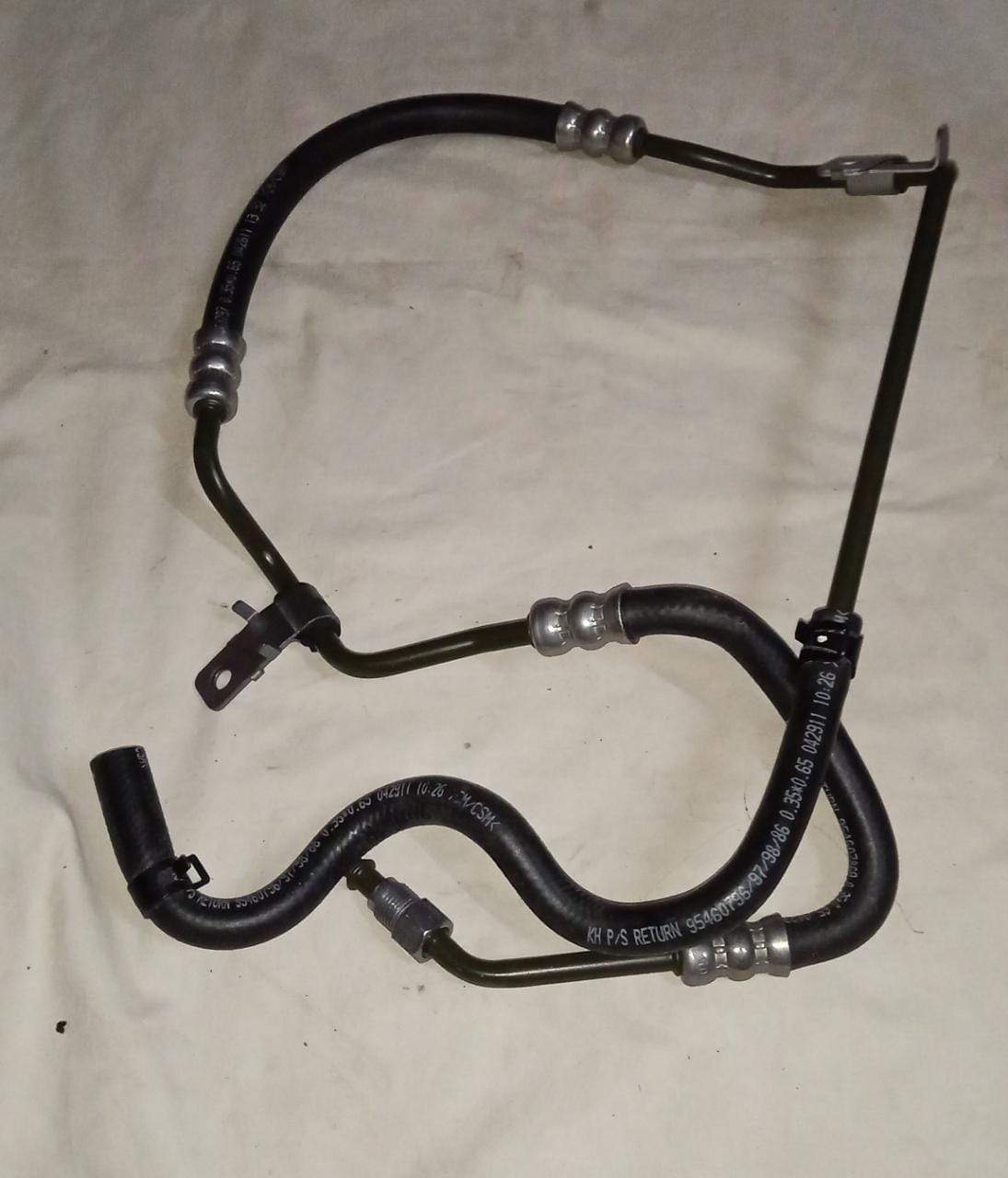 General Motors power steering gear outlet hose assembly for Chevrolet Beat engine, showing the flexible rubber hose and fittings.