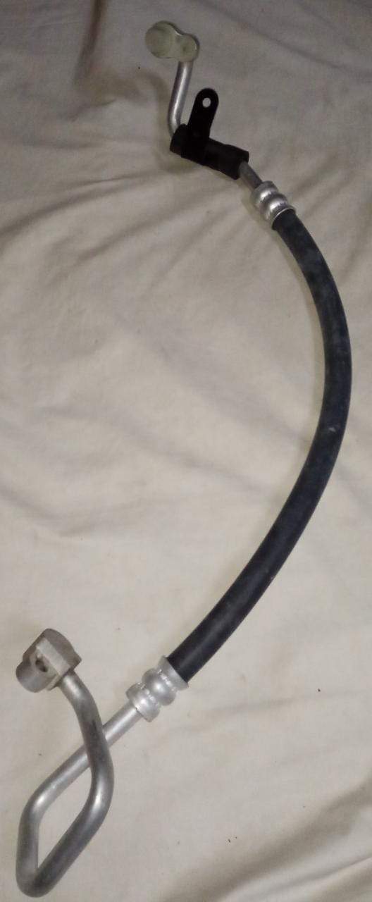 Flexible AC hose for Chevrolet Tavera engine by General Motors, showing the black rubber hose with metal fittings.