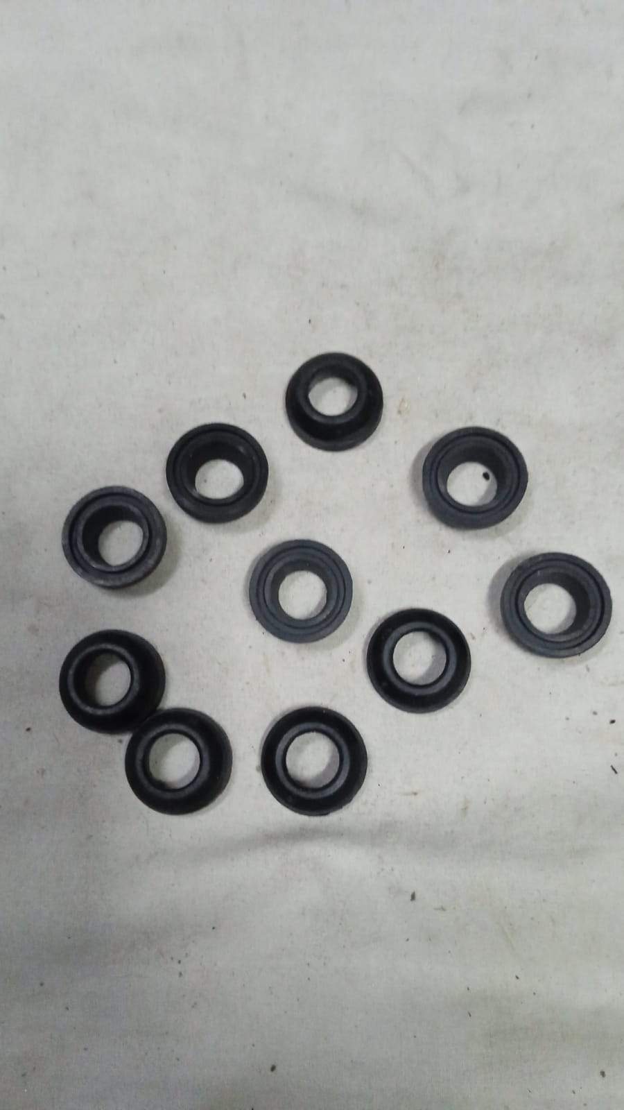 General Motors Grommet Spark One Piece, automotive engine component, white plastic part with a hole for fitting.