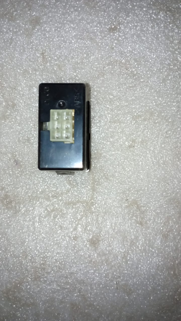 General Motors headlamp level switch for Aveo, showing the switch component with adjustment knob and wiring connections.