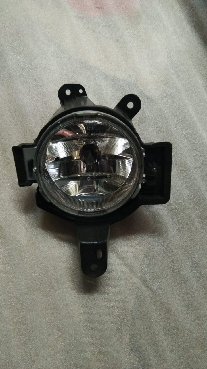 Front left fog lamp for Chevrolet Spark, OEM part from General Motors, showing the clear lens and mounting bracket.