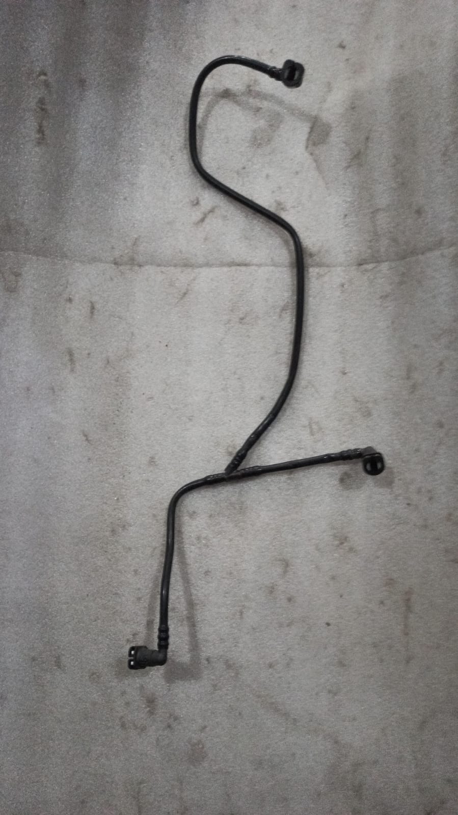 Fuel return pipe assembly for Chevrolet Beat by General Motors, showing the metal pipe with connectors and fittings.