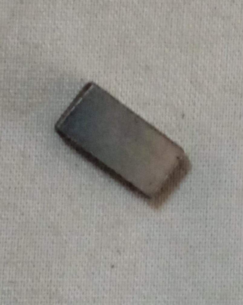 General Motors T97597142 drive gear key feather for Tavera vehicle, showing the small metal component with gear teeth and key slot.