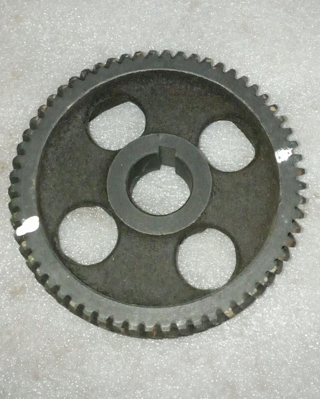 General Motors cam shaft gear for Tavera vehicle, showing the gear's detailed metal construction and teeth for engine timing.
