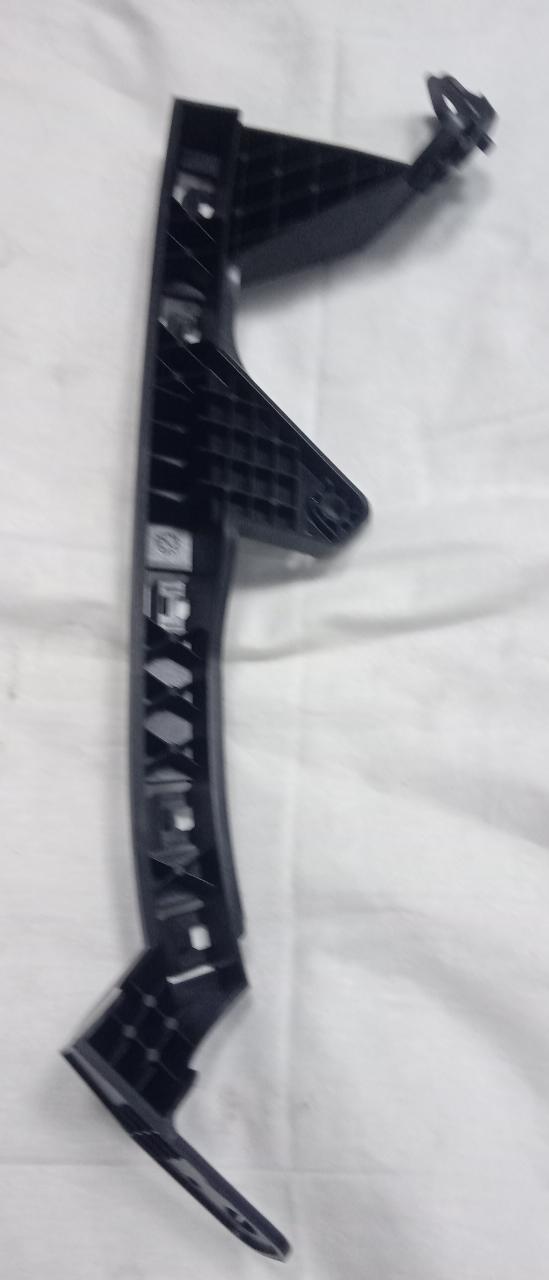 Honda WRV right side headlight bracket, part 71140TXKK00, shown in the image with mounting details and black plastic finish.