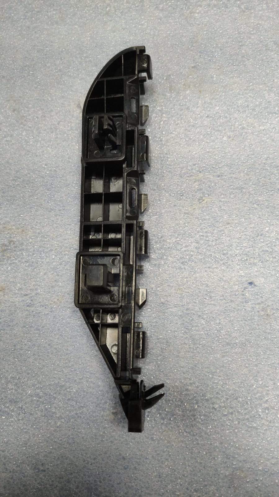 Honda WRV front bumper right side bracket 71193TXKK00, close-up view of the vehicle's front bumper component.