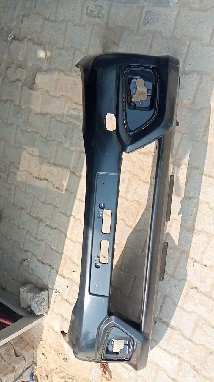 Honda Brio front face bumper in black with chrome accents, showing the exterior view of the bumper assembly.