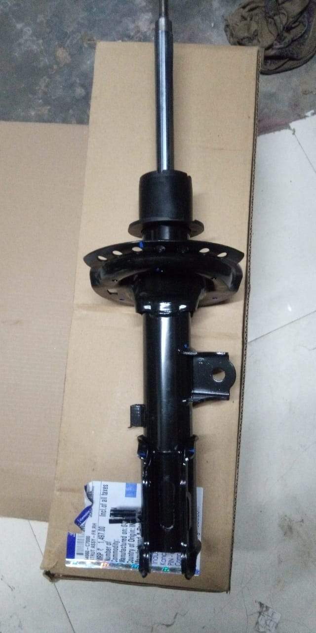 Hyundai I20 Elite front right shock absorber, part #54660C7000, shown in a close-up image of the vehicle's suspension component.