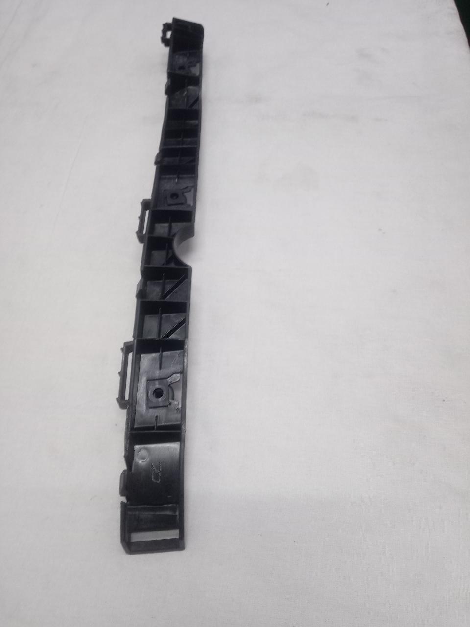 Mahindra XUV 500 rear right bumper bracket in black, part number 0118BAW00440N, mounted on vehicle.